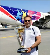  ??  ?? Indian batting legend and 2011 World Cup winner Virender Sehwag with the 2019 ICC World Cup trophy