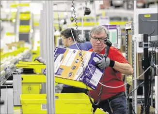  ?? TED S. WARREN / ASSOCIATED PRESS 2015 ?? Amazon.com workers process orders at its fulfillmen­t center in DuPont, Washington, in 2015. Amazon said Wednesday that it will hold job fairs at facilities around the country next Wednesday. Company officials said nearly 40,000 of the 50,000 jobs would...