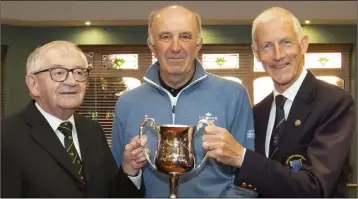  ??  ?? Martin O’Brien (left) presenting his trophy to Richard Cuddihy (winner) as New Ross Club Captain Martin Carroll looks on.