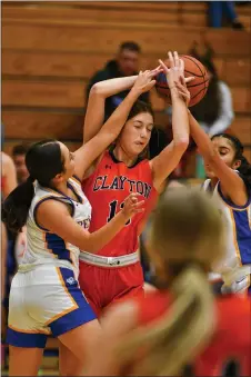  ?? JOHN T. DENNE/For the Taos News ?? Don’t swat at Yellowjack­ets, it only makes them angry. Peñasco’s Sierra Atencio, left, and Rochelle Lopez take their best swats at Clayton Yellowjack­et’s Morgan Crisp in first-quarter action of their Wednesday (Dec. 21) game in Peñasco.