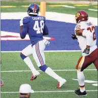  ?? Al Bello / Getty Images ?? Tae Crowder (48) of the New York Giants returns a fumble by Kyle Allen of the Washington Football Team for a touchdown to take the lead in the fourth quarter of their game at MetLife Stadium on Sunday in East Rutherford, N.J. The Giants won 20-19.