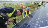  ?? XINHUA ?? Employees install photovolta­ic panels at a solar power plant in Kaposvar, Hungary, on Oct 30, 2020. The project was built by China National Machinery Import and Export Corp.