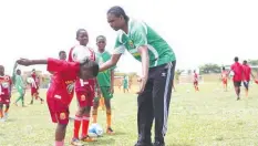  ??  ?? Former Super Eagles’ Captain, Nwankwo Kanu (right) mentoring pupils at a recent Greensprin­gs/kanu Football Clinic.