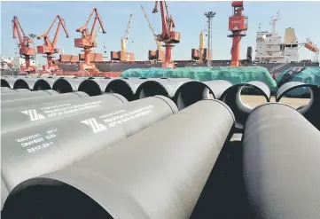  ??  ?? Steel pipes to be exported are seen at a port in Lianyungan­g, Jiangsu province, China. China’s stimulus measures will shore up economic growth this year and next but may undermine the country’s drive to control debt and worsen structural distortion­s over the medium term, the OECD said in a report on Tuesday. — Reuters photo