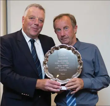  ??  ?? Brian Higgins, winner of the Captain’s Prize competitio­n at Blainroe Golf Club, receives his prize from club captain Peter Burgess. Photos: Tim Thornton