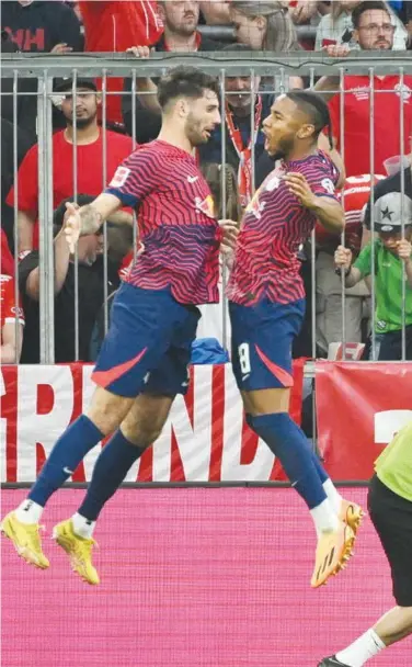  ?? Reuters ?? RB Leipzig’s Dominik Szoboszlai (left) celebrates with Christophe­r Nkunku after scoring a goal against Bayern Munich on Saturday.