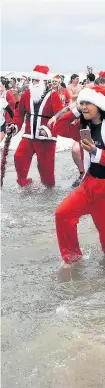  ??  ?? More than 1,000 people took part in the Porthcawl Christmas Day swim this year