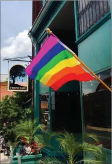  ?? PHOTO PROVIDED BY FIREFLY CAFÉ ?? A LGBT Pride flag hangs outside of the all-vegan Firefly Café restaurant in Boyertown. The restaurant owners will celebrate plantbased foods, nature and unity during ItalFest, a multicultu­ral event, taking place on Saturday, June 29.