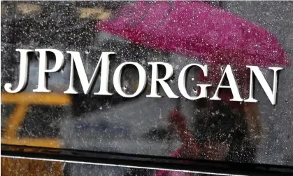  ?? Photograph: Timothy A Clary/AFP/Getty Images ?? JP Morgan is the first big US lender to increase the money put aside for defaults.