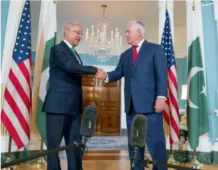  ?? AP ?? Foreign Minister Khawaja Asif is received by US Secretary of State Rex Tillerson at the State Department in Washington. —