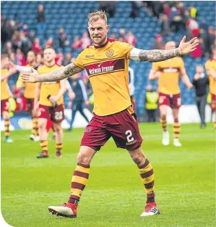  ??  ?? Richard Tait celebrates Motherwell’s convincing win at full-time at Hampden