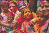  ?? (AP/Anupam Nath) ?? Indians smeared in color participat­e in Holi festival celebratio­ns in Gauhati.