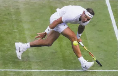  ?? Kirsty Wiggleswor­th / Associated Press ?? Rafael Nadal bends low to return the ball to Sam Querrey on the way to a quarterfin­al victory.