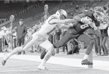  ?? Tim Warner ?? Cy-Fair’s Erick Hallett, right, finds the end zone on a 30-yard fourth-quarter reception despite the best efforts of Austin Westlake’s Keaton Jones. While playing defense in the first half, Hallett had an intercepti­on.