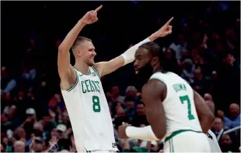  ?? (AP PHOTO/WINSLOW TOWNSON) ?? Kristaps Porzingis celebrates after making a 3-point basket against the Oklahoma City Thunder during Wednesday’s game in Boston.