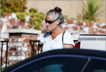  ?? JAE C. HONG — THE ASSOCIATED PRESS FILE ?? In this Thursday file photo, Colleen Long, mother of shooting suspect David Ian Long, leaves her house in Newbury Park. If authoritie­s have concluded why Ian David Long shot and killed 12 people at a Southern California bar, they aren’t sharing, and his family isn’t talking, either. That has left a community still in mourning to wonder why, but also ask who was the man who shattered the sense of security in the Los Angeles suburb of Thousand Oaks?