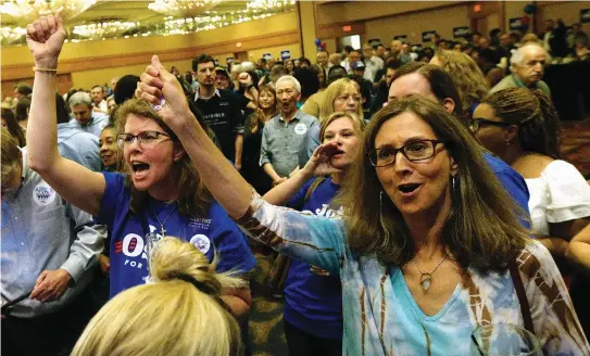  ??  ?? SUPPORTERS OF Jon Ossoff cheer at the candidate’s Election Night party in Sandy Springs, Georgia in April.