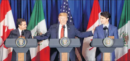  ?? CP PHOTO ?? Prime Minister Justin Trudeau, right to left, participat­es in a signing ceremony for the new North American Free Trade Agreement with President of the United States Donald Trump and President of Mexico Enrique Pena Nieto in Buenos Aires, Argentina, on Friday.