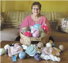  ?? PHOTO COURTESY OF DEBBIE THORNTON ?? REACHING OUT: Debbie Thornton, a breast cancer survivor, holds a basket of handmade Knitted Knockers.