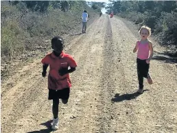  ?? Picture: SHANI STEWART ?? HOW FAR CAN YOU GO? Practicing cross-country on the gravel roads at Shaw Park Primary School are U7 pupils Okuhle Halom, left, and Savanna Stewart