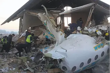  ?? Kazinform / Tribune News Service ?? A Bek Air Fokker 100 passenger plane carrying 98 people crashed into a concrete wall and a twostory building minutes after takeoff from former capital of Almaty. The cause of the predawn crash is unclear.