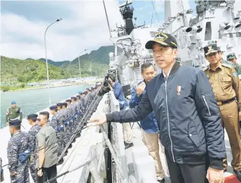  ?? AFP photo ?? This handout picture shows Widodo (right) during his visit to a military base in the Natuna islands, which border the South China Sea. —