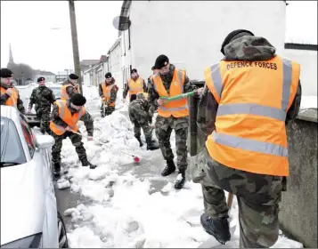  ??  ?? Members of the 3rd Army Battalion of the Defence Forces on snow clearing duty in The Faythe.