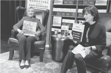  ??  ?? Former Secretary of State Hillary Clinton, with bookstore owner Lissa Muscatine (right), takes the stage to discuss her new book ‘What Happened’ as she launches a recent 15-city book tour at the Warner Theatre in Washington. — Reuters photo