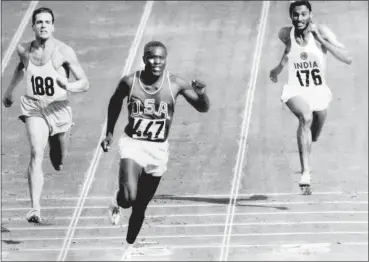  ?? ASSOCIATED PRESS FILE ?? Rafer Johnson of the United States, center, finishers the fourth heat of the decathlon 100-meter dash at the 1960 Olympics in Rome, Italy.