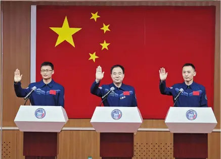  ?? ?? Taikonauts Jing Haipeng (center), Zhu Yangzhu
(right) and Gui Haichao for the upcoming Shenzhou-16 mission wave to journalist­s at the Jiuquan Satellite Launch Center in northwest China yesterday. — Xinhua