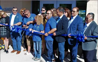  ?? PHOTO MICHAEL MARESH ?? el Centro Mayor edgard Garcia, with dignitarie­s and city officials standing next, to him cuts the ribbon at saturday’s grand opening of the Aquatic Center.