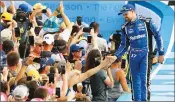  ?? Orlando Sentinel/tns ?? NASCAR driver Ricky Stenhouse, Jr. greets fans as he is introduced at the Daytona 500, at Daytona Internatio­nal Speedway, Sunday, February 17, 2019. Stenhouse captured the pole Sunday for next week’s 62nd annual Daytona 500.