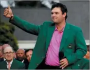  ?? CHRIS CARLSON — THE ASSOCIATED PRESS FILE ?? Patrick Reed gives a thumbs up after being presented with the championsh­ip trophy after winning the Masters golf tournament in Augusta, Ga. Reed should be considered a front-runner for golf’s best player through six months of the year.