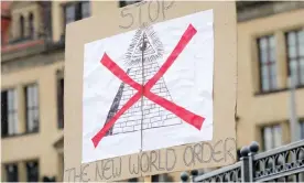  ?? Photograph: Chad Buchanan/Getty Images ?? A protester’s sign saying ‘Stop The New World Order’ near the venue of the 2016 Bilderberg conference in Dresden, Germany.