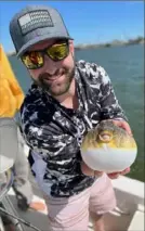  ?? ?? Jon Gentile with a blowfish he caught during a fishing trip.