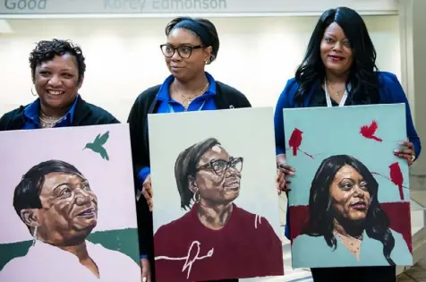  ?? Blue Sky News/Pittsburgh Internatio­nal Airport photos ?? Shelley Snyder, left, April Laukaitis and Cara Kuczma with portraits painted by Korey Edmonson.