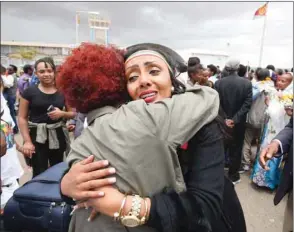  ??  ?? Relatives embrace after meeting at Asmara Internatio­nal Airport after one arrived aboard the Ethiopian Airlines flight from Addis Ababa.