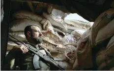  ?? — AFP ?? A Syrian rebel-fighter takes position on the frontline facing government forces in the Al Rashedin area west of Aleppo in northweste­rn Syria, on Tuesday.