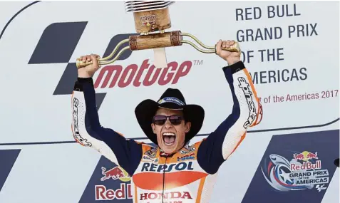  ??  ?? Taking the bull by the horns: Marc Marquez holding up his trophy after winning the Grand Prix of the Americas in Austin, Texas, on Sunday. — AP