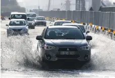  ?? Pawan Singh / The National ?? Traffic makes its way through water after heavy rain in Dubai