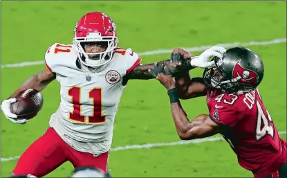  ?? MARK LOMOGLIO/AP PHOTO ?? Kansas City Chiefs wide receiver Demarcus Robinson (11) stiff arms Tampa Bay Buccaneers defensive back Ross Cockrell (43) after a catch during the second half of Sunday’s game in Tampa, Fla. The Chiefs won 27-24.