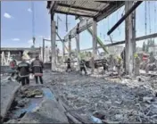  ?? AFP ?? Rescuers search the rubble of the Amstor mall in Kremenchuk, on Tuesday. A Russian missile strike on the crowded mall in Ukraine killed at least 18 people. At least 36 people are still missing.