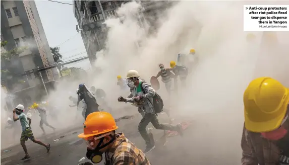  ?? Hkun Lat/Getty Images ?? Anti-coup protesters after riot police fired tear gas to disperse
them in Yangon