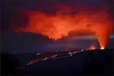  ?? Associated Press ?? Lava erupts from Hawaii’s Mauna Loa volcano on Wednesday near Hilo. The eruption has disrupted power to a station that measures carbon dioxide in the atmosphere.