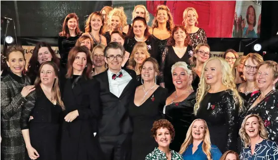  ??  ?? Night to remember: Members of the choir at the Military Wives film premiere with conductor Gareth Malone, centre, and stars Kristin Scott Thomas, far left, and Sharon Horgan, third left Picture: DAVE BENETT/WIREIMAGE