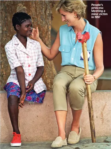  ??  ?? People’s princess: Meeting a mine victim in 1997