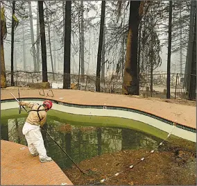  ?? AP/JOHN LOCHER ?? A search and rescue team member checks a swimming pool for remains Tuesday at a mobile home park in fire-ravaged Paradise, Calif., where a number of people remain missing.