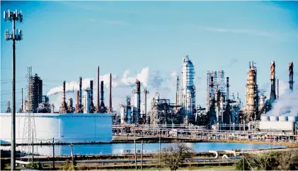  ?? Staff file photo ?? Exxon Mobil’s Baytown Refinery is seen in 2021. The oil giant seeks to acquire industry rival Pioneer Natural Resources.