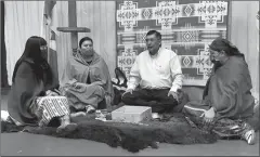  ?? Photo submitted by Catholic Central High School ?? Catholic Central principal Joanne Polec, Emily Fox and Annette Bruised Head sit around Kainai Elder Tom Little Bear before he paints their faces during the Blackfoot naming ceremony on Wednesday.