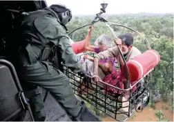  ?? PICTURE: REUTERS ?? ESCAPE: People are airlifted by the Indian Navy during a rescue operation in the flooded southern state of Kerala, India, at the weekend.